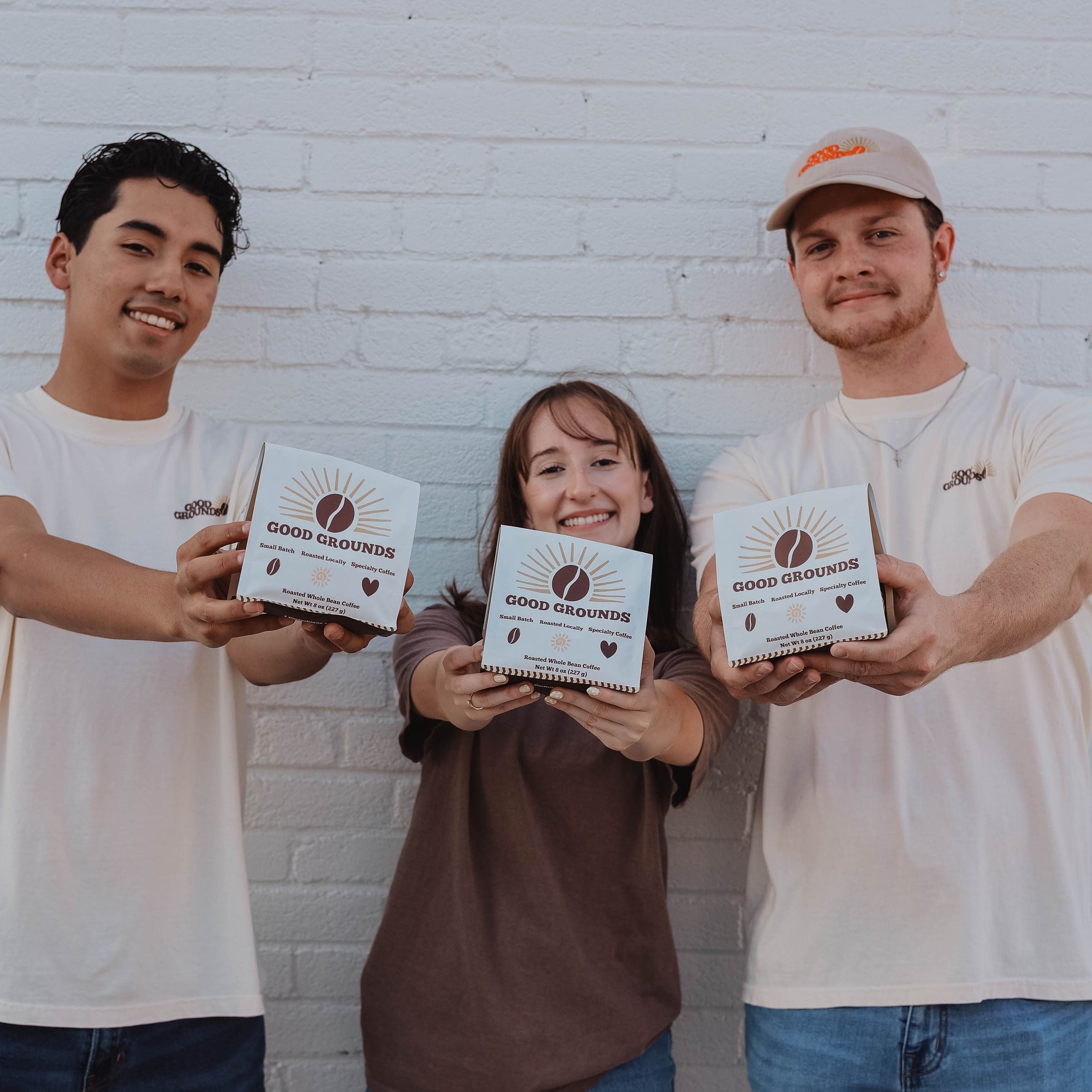 Good Grounds Coffee Roasters Dade City Florida Land'o'lakes Wesley Chapel Zephyrhills Lutz Roasted Coffee Beans 3 people holding a bag out