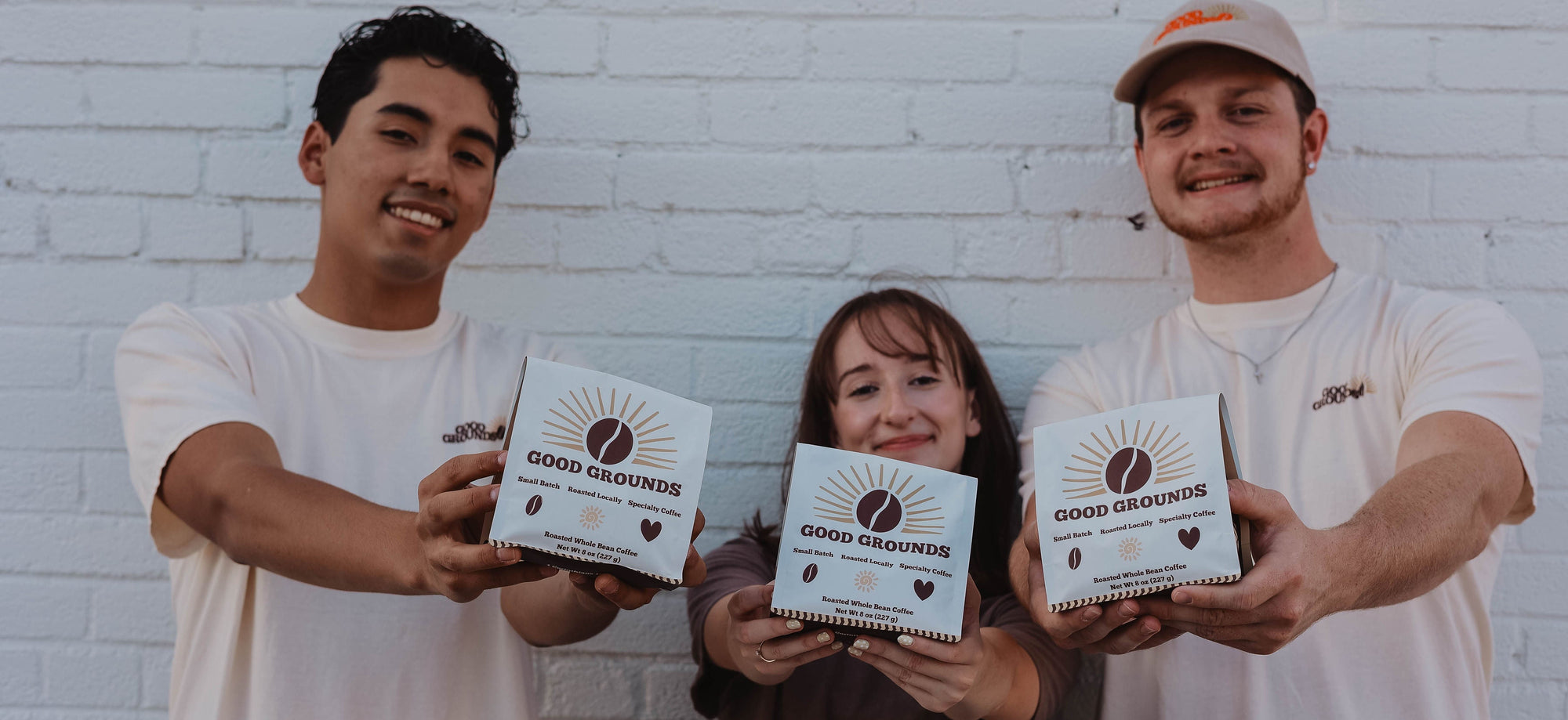 Good Grounds Coffee Roasters Dade City Florida Land'o'lakes Wesley Chapel Zephyrhills Lutz Roasted Coffee Beans 3 people holding roasted coffee bags up