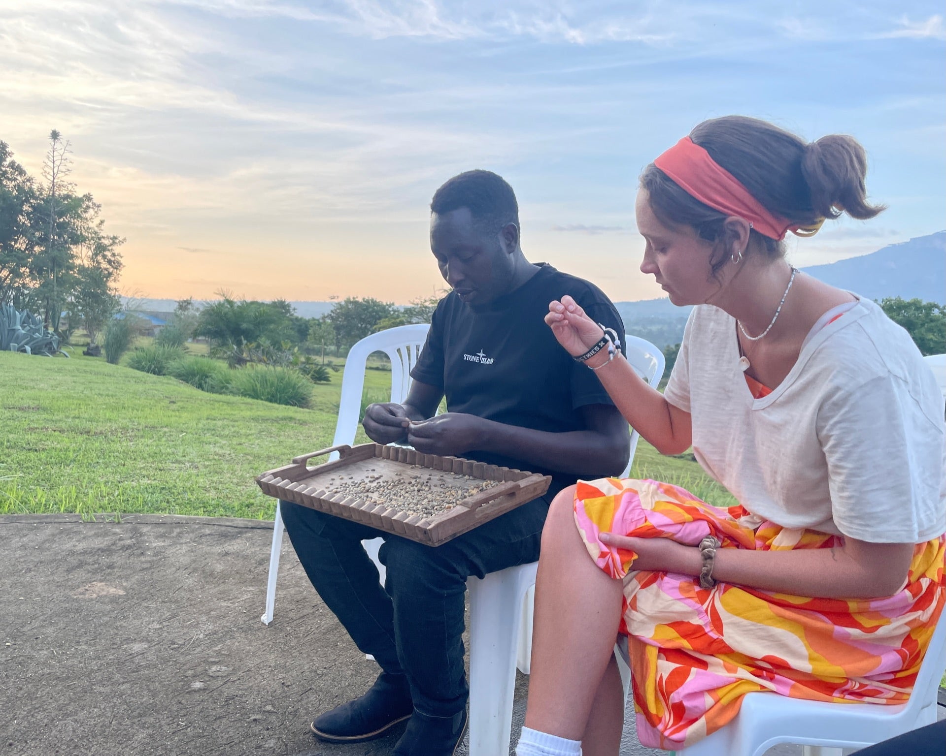 Dade City Roaster in uganda inspecting specialty coffee green beans