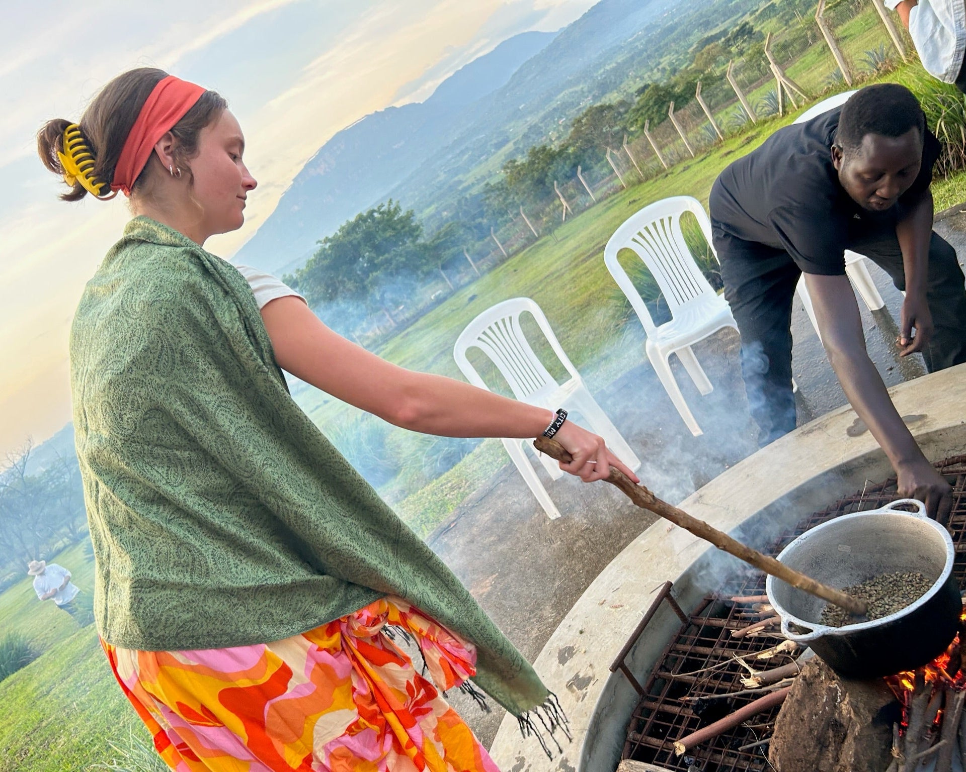 Local Coffee Roaster in Uganda roasting coffee with the locals